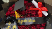 Graduation rose bouquet with black cap, diploma scroll and “Congratulations” ribbon, perfect celebratory flower gift
