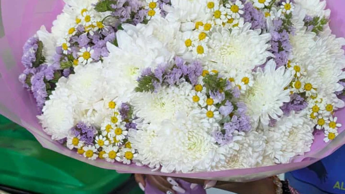 White and soft purple condolence bouquet with chrysanthemums, gentle sympathy flowers for expressing support and remembrance