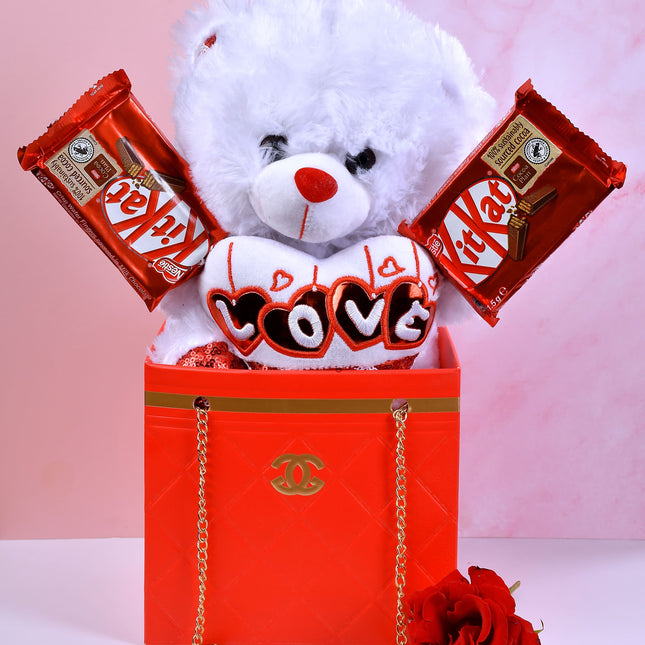 The Chanel Bag gift set with teddy bear, KitKat chocolates, heart cushion, and red rose.