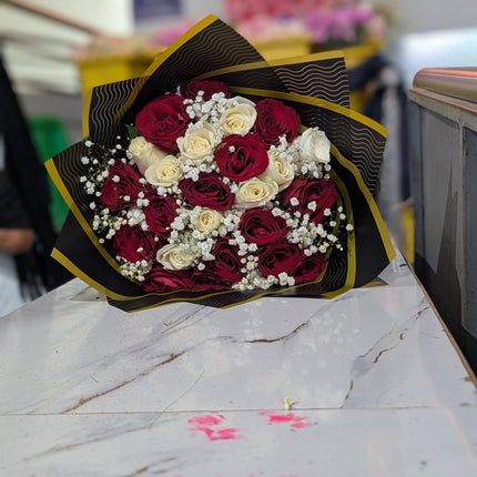 Classic bouquet with red and white roses, baby’s breath, and black gold wrap arrangement.