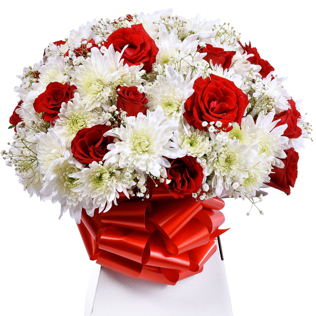 The Amor bouquet with red roses, white chrysanthemums, and baby’s breath in a box with red ribbon.