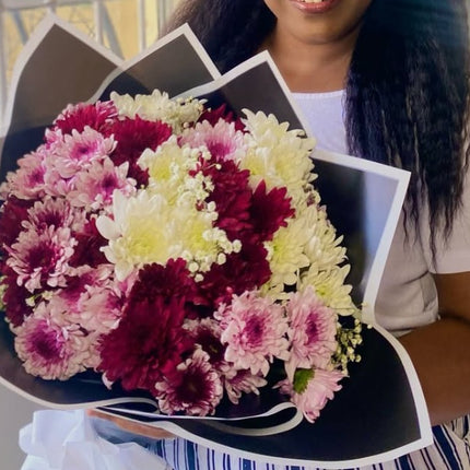 For Her bouquet with red, pink, and white chrysanthemums wrapped in elegant black and white paper.
